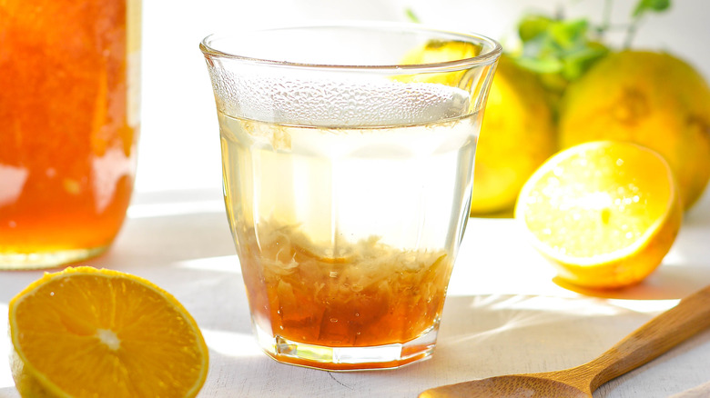glass of yuzu juice with yuzu fruit on table