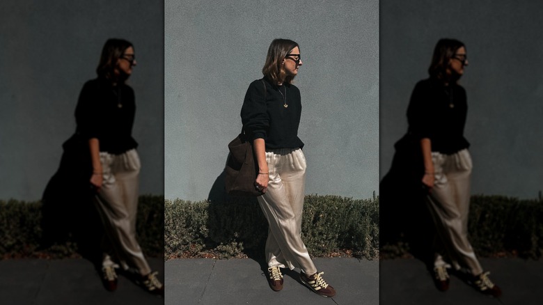 Woman wearing silk pants with sneakers