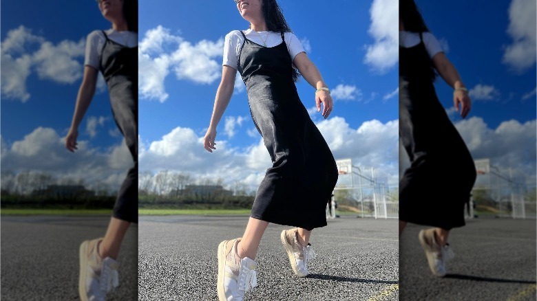 Woman in black slip dress and t-shirt