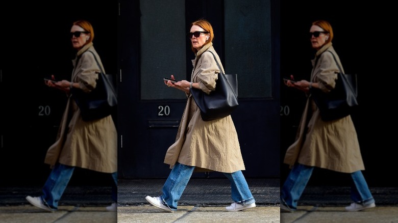 Julianne Moore walking in loose denim and white sneakers