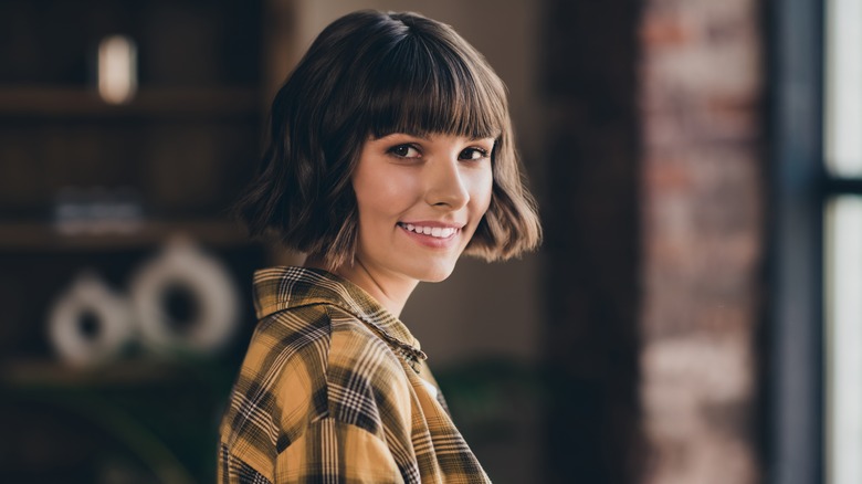 Woman cutting bangs