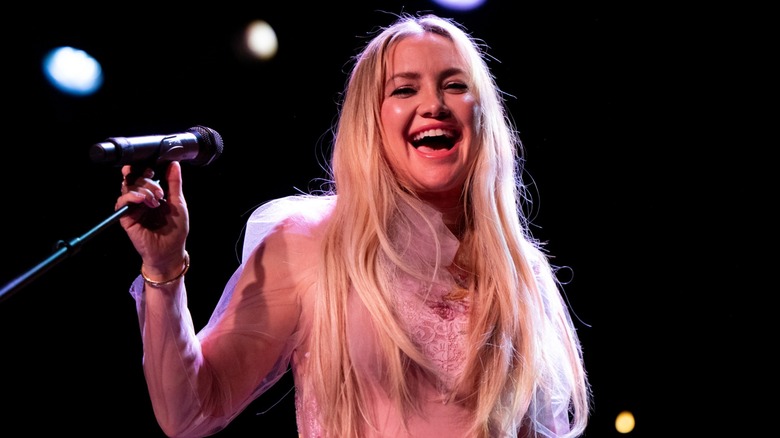 Kate Hudson singing on stage in 2024