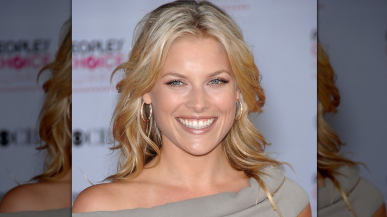 Ali Larter with curly blow out wearing hoop earrings