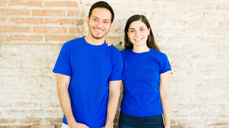 Couple wearing matching blue t-shirts and jeans