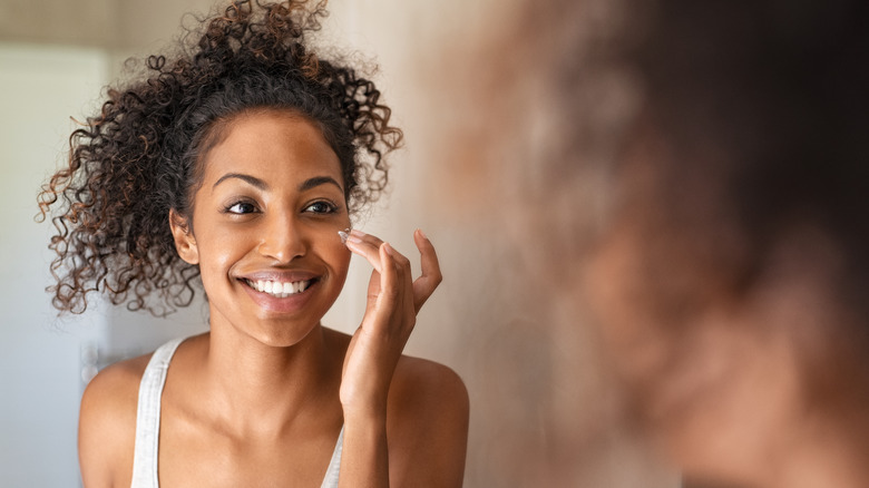 Woman applying skincare
