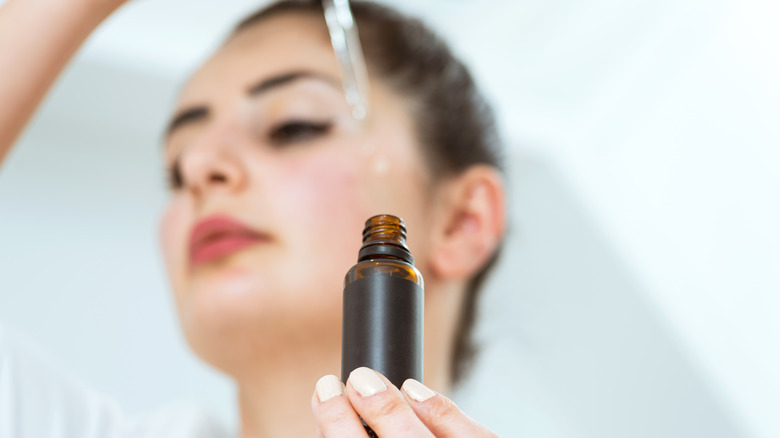 Woman applying hyaluronic acid