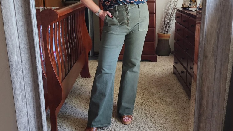 A woman in olive colored jeans