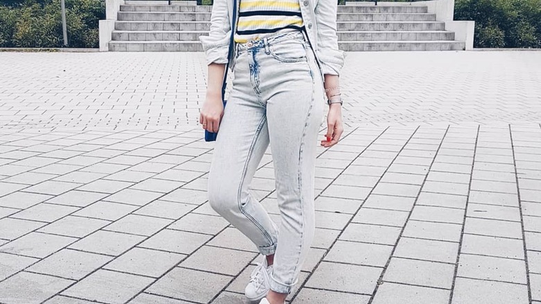 A person wearing light denim pieces