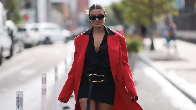 Woman walking outside in red and black 