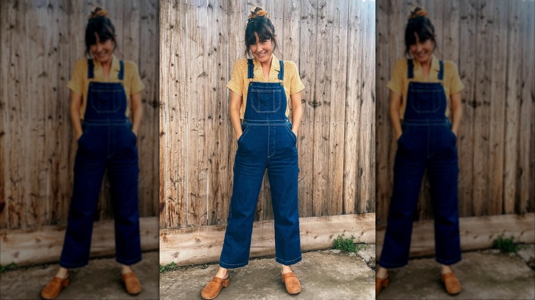 A woman in overalls and a light yellow top