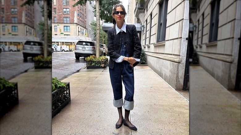 A woman on Instagram wearing overalls with a boucle jacket and black shoes