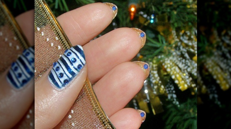 Gold underside mani with blue rhinestones