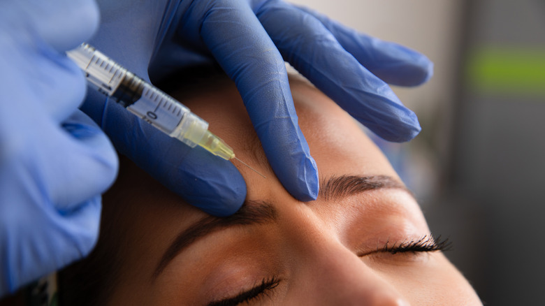 Doctor injecting filler