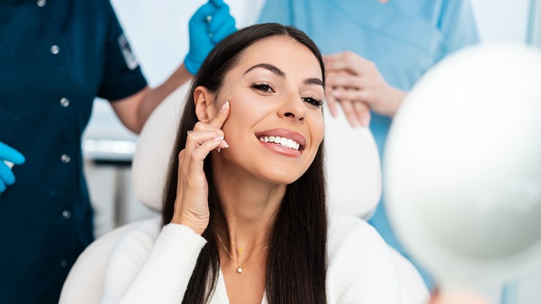 Woman touching face smiling