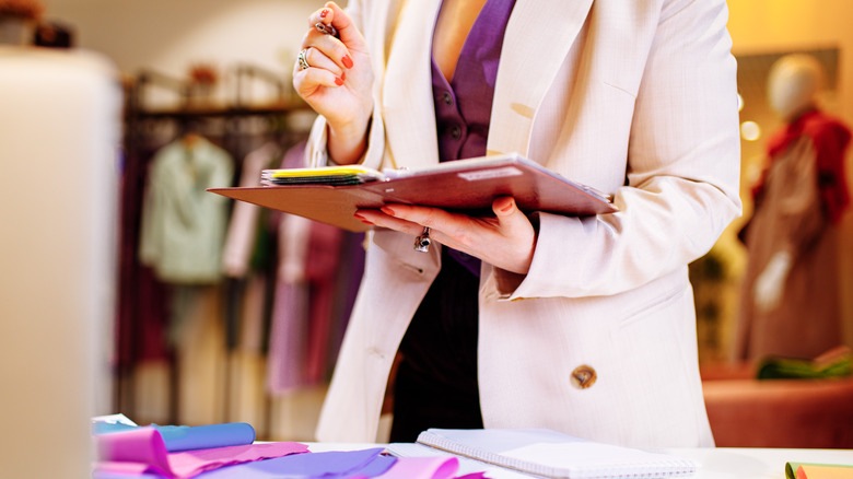 a woman with a notebook in a blazer