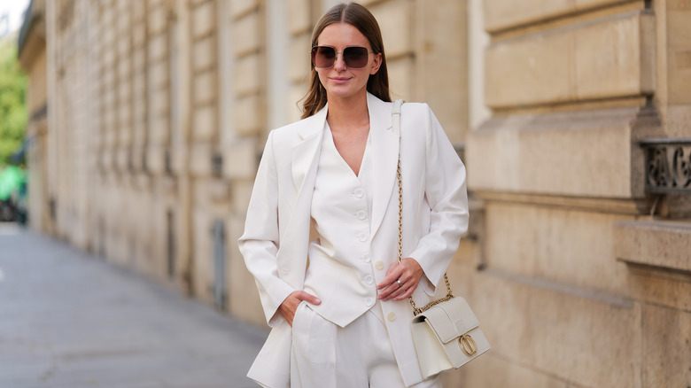 A woman in Paris in an all white outfit