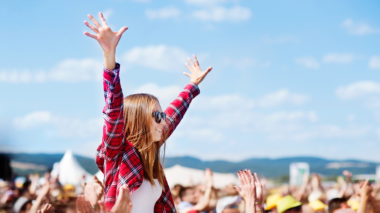 Girl on shoulders at concert