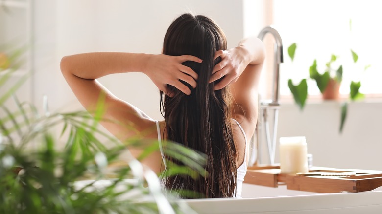 Woman applying hair mask