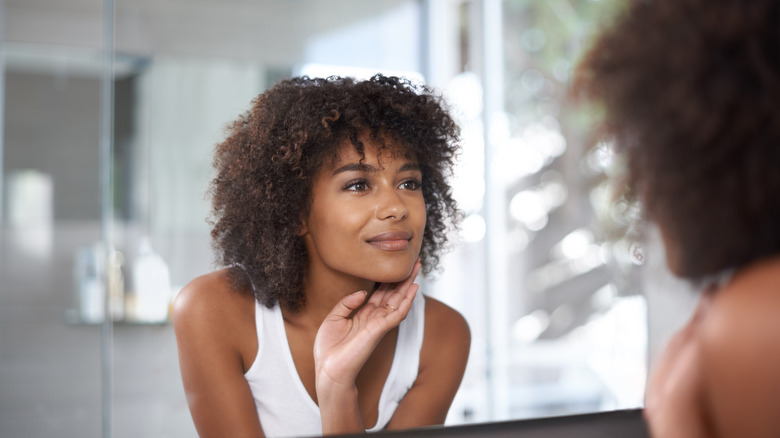 woman looking at her reflection