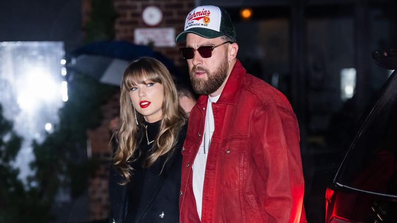 Paparazzi shot of Taylor Swift and Travis Kelce walking