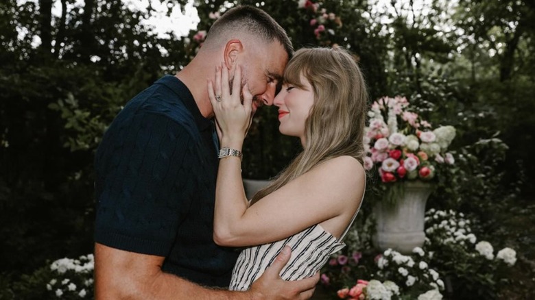 Taylor Swift and Travis kelce embracing with foreheads touching