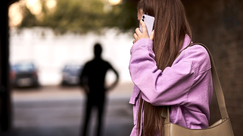 woman being stalked by man