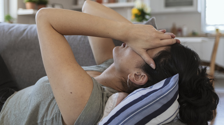 woman holding head