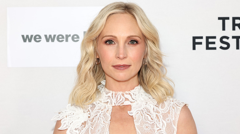 Close-up of Candice King posing in a lacey, white dress at a film festival