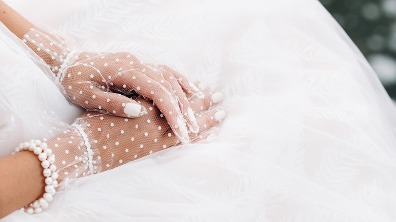 Bride wearing lace gloves