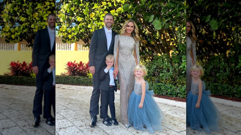 Lara Trump standing in a silver dress with Eric Trump and two small children