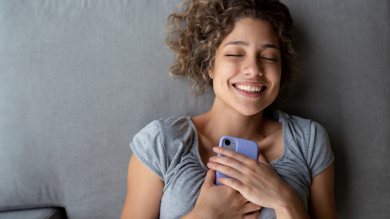 Smiling and holding phone