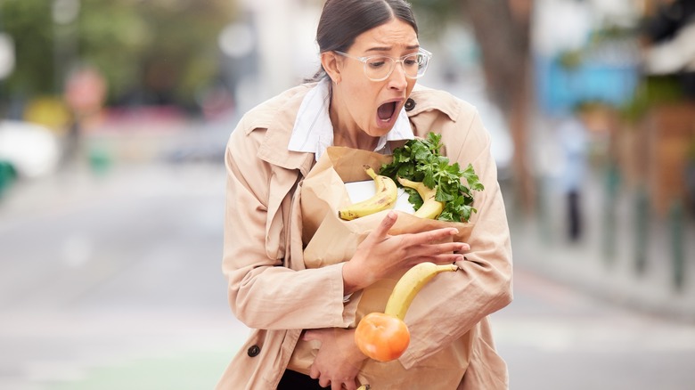 Woman dropping groceries