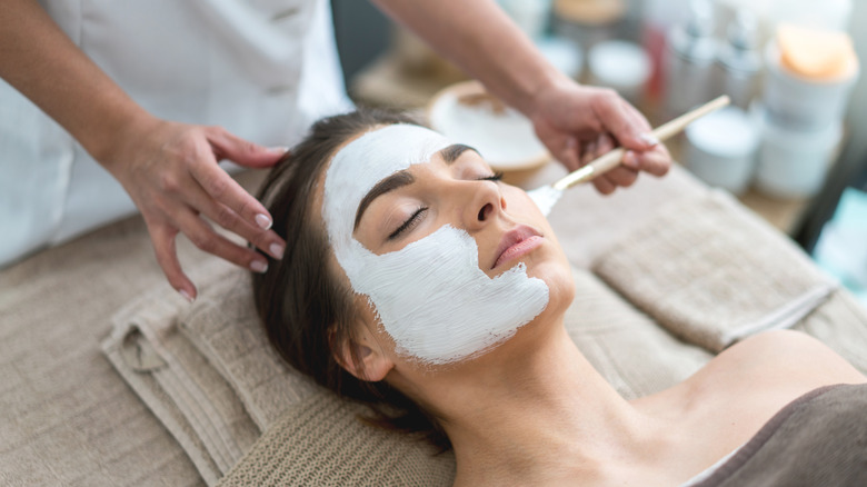 Applying a face mask to a woman's face