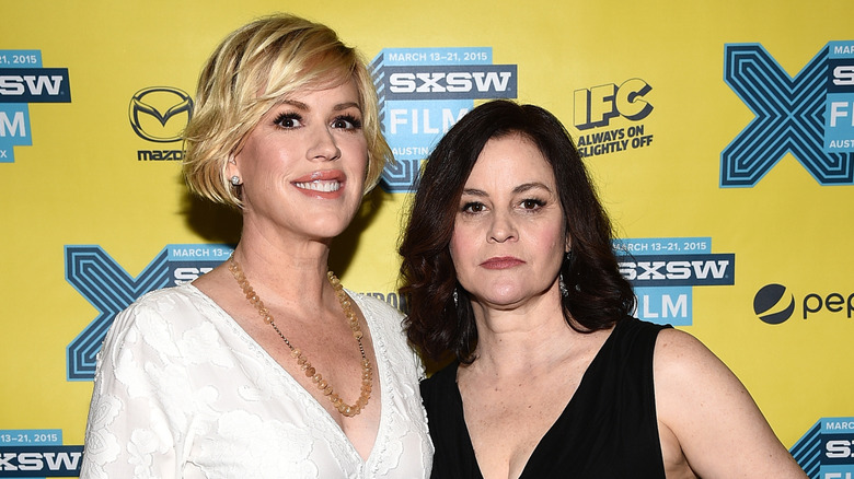 Molly Ringwald and Ally Sheedy standing together on the red carpet in 2015