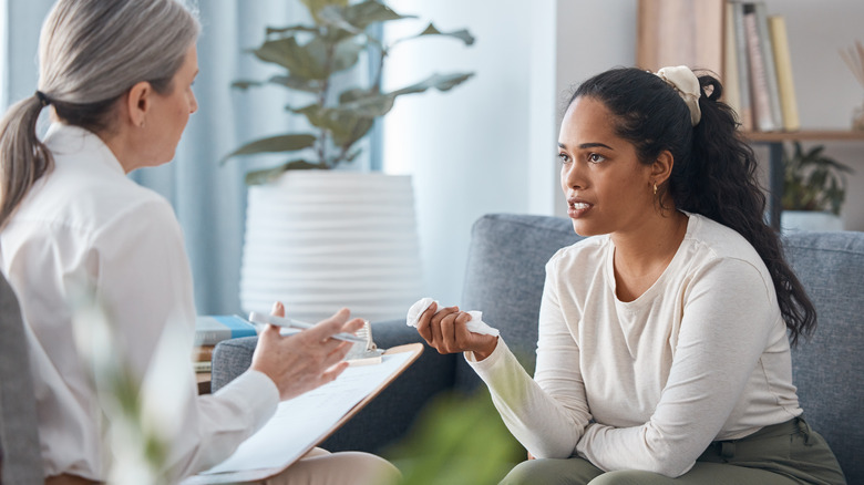 Therapist and patient sitting and talking