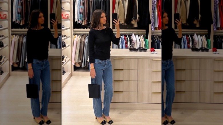 Rhode co-founder styles two-toned Chanel slingback pumps with simple black knit top and jeans outfit