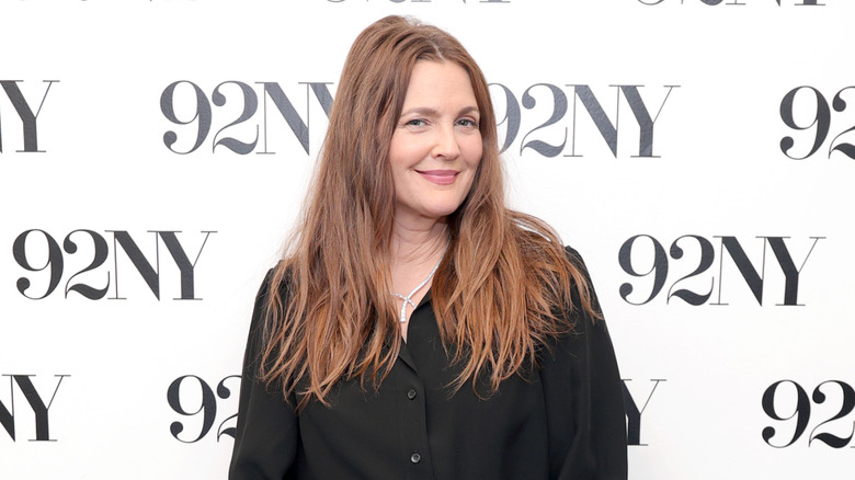 Drew Barrymore smiling while wearing a black button-up