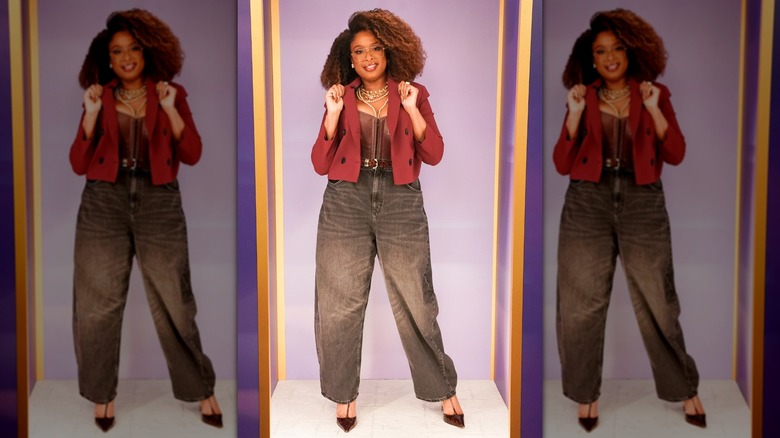 Jennifer Hudson holding on to her blazer lapels while posing for an outfit snapshot