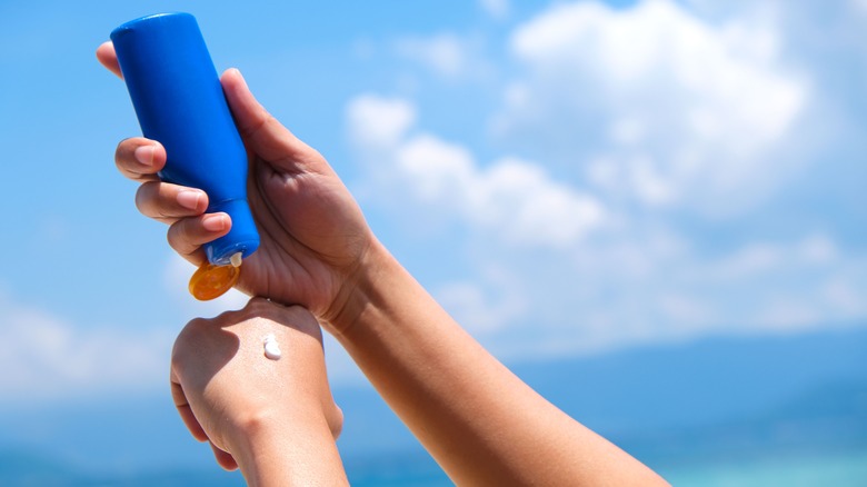 Woman applying sunscreen to hand