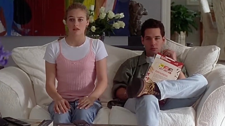 Cher sitting on the sofa with Josh in Clueless