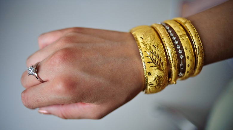 Person wearing multiple metal bangles