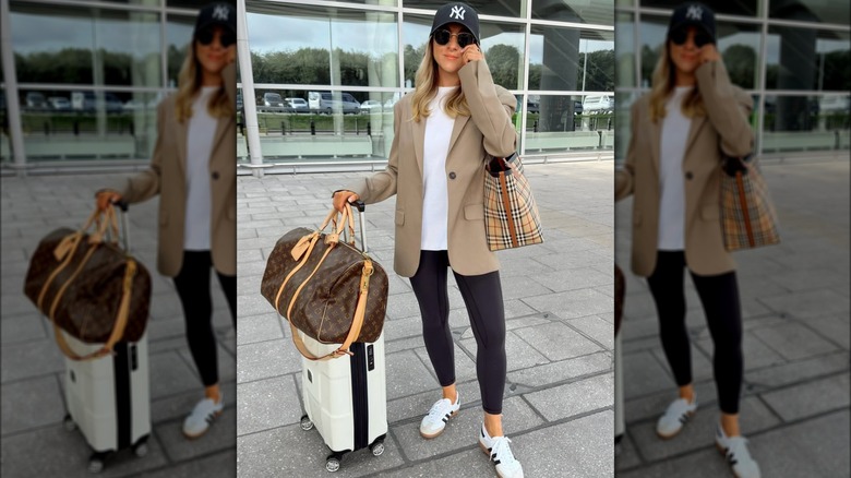 A woman in a baseball cap, a blazer and leggings at the airport