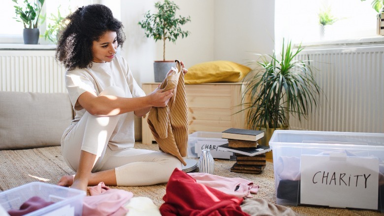 Woman sorts clothes for donation