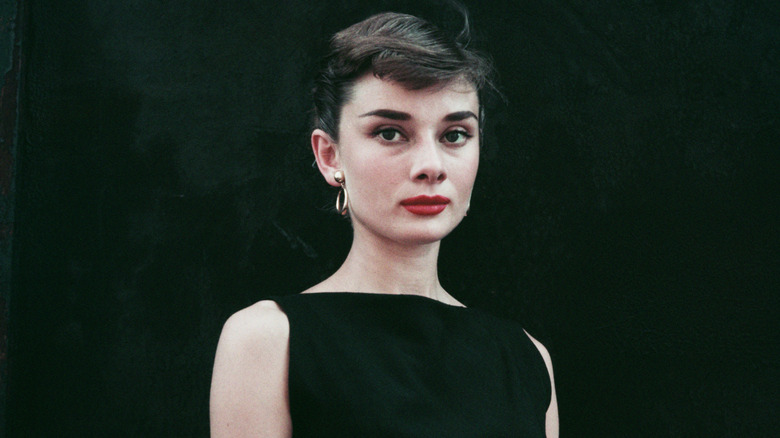 Audrey Hepburn in a black sleeveless dress, circa 1955.