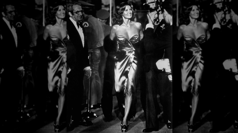 Raquel Welch walking the red carpet at the 1973 Oscars in a pink, strapless, satin gown