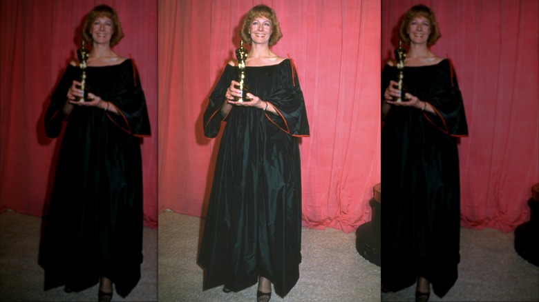 Vanessa Redgrave wearing a black dress with billowy sleeves while holding her Oscar at the 1978 ceremony