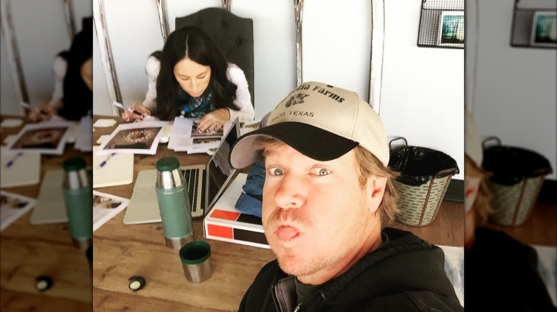 Chip Gaines sharing a photo of himself making a silly face with Joanna Gaines in the background