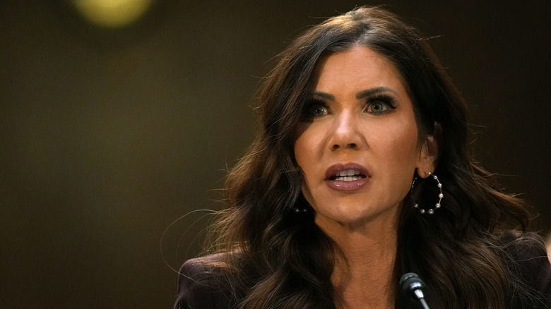 Kristi Noem speaking into a small microphone