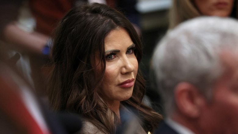 Kristi Noem looking to the side and frowning slightly