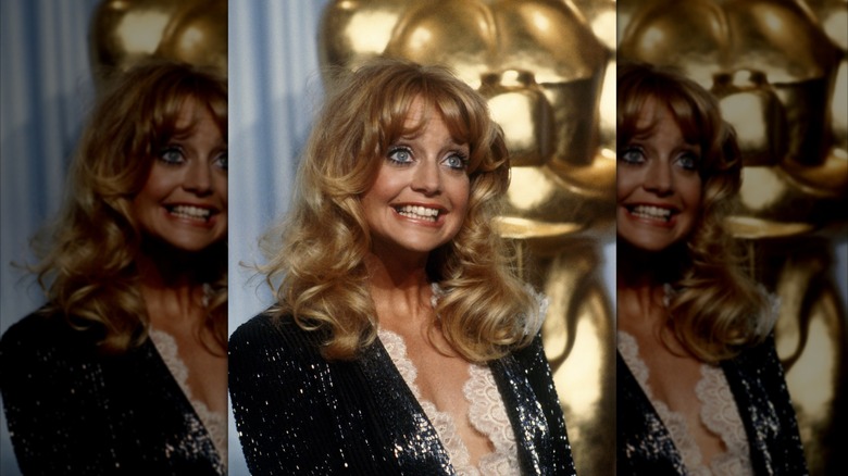 Goldie Hawn smiles wearing a black blazer embellished with sequins
